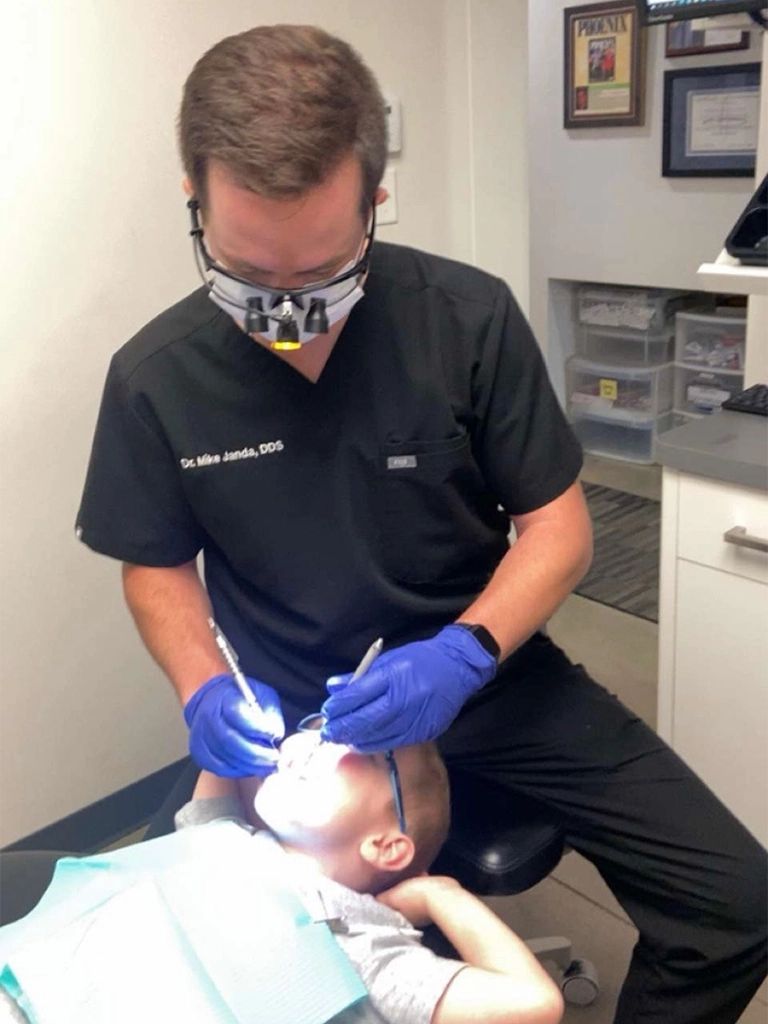 Dr. Janda treating a patient during a dental visit