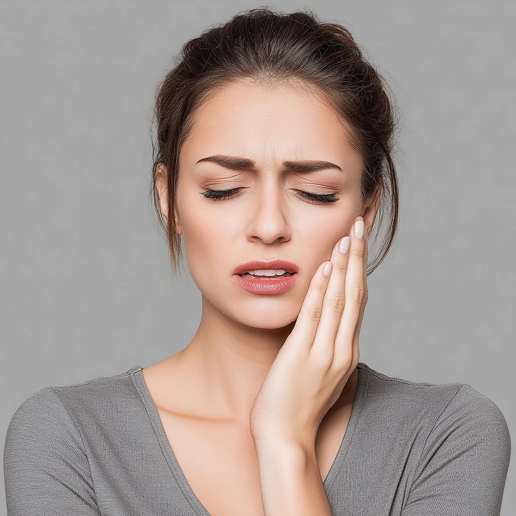 Woman experiencing tooth pain requiring urgent dental care near me